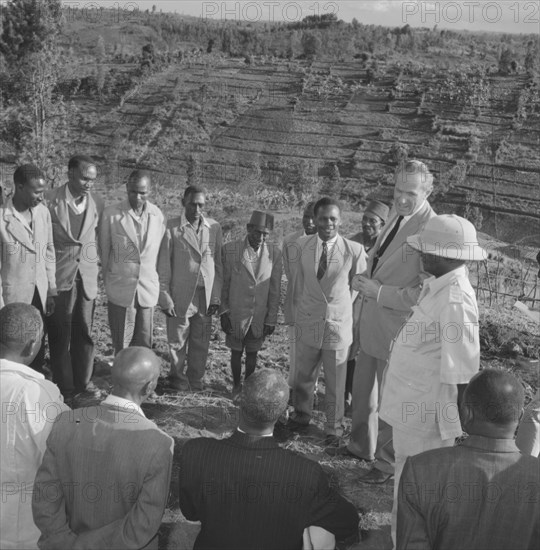 Lennox-Boyd visits Fort Hall. Alan Tindal Lennox-Boyd (1904-1983) meets Kenyan elders of the Fort Hall district, guided by Chief Ignatio who stands by his side wearing a solatopi hat. Fort Hall, Kenya, 15 October 1957., Central (Kenya), Kenya, Eastern Africa, Africa.