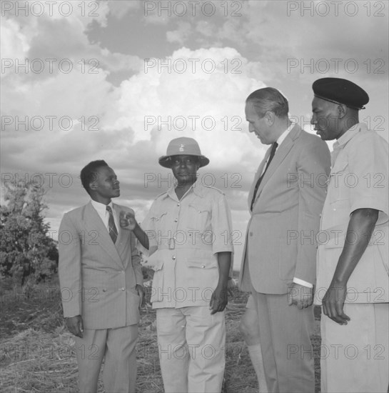Lennox-Boyd visits Fort Hall. Alan Tindal Lennox-Boyd (1904-1983) visits the Fort Hall district, guided by Chief Ignatio, the central figure in the solatopi hat. Fort Hall, Kenya, 15 October 1957., Central (Kenya), Kenya, Eastern Africa, Africa.