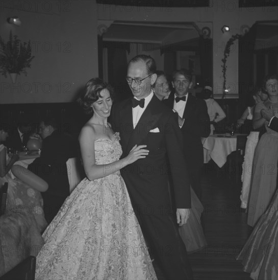 Guests at the Limuru Hunt Ball. A formally dressed couple share a private joke on the dance floor at the Limuru Hunt Ball. Kenya, 19 October 1957. Kenya, Eastern Africa, Africa.