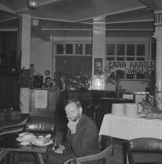 Charles Trotter at dinner. A rare photograph of Charles Trotter, a professional photographer whose work is widely represented in this collection, captured at dinner at the Limuru Hunt Ball. Kenya, 19 October 1957. Kenya, Eastern Africa, Africa.