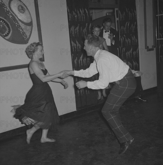 Dancing at the Equator Club. A couple dance energetically at the Equator Club. The woman, identifed as 'Wanda', wears a strapless dress that flares out as she dances. Nairobi, Kenya, 19 October 1957. Nairobi, Nairobi Area, Kenya, Eastern Africa, Africa.