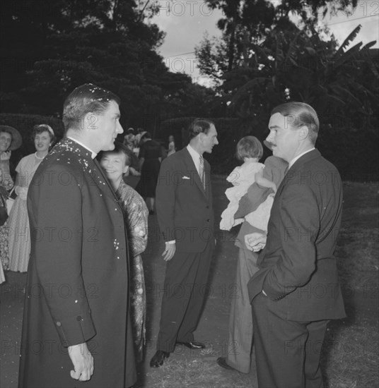 Padre at the Coltart wedding. Covered in confetti, the padre chats to guests outside a church following the wedding ceremony of the Coltart couple. Kenya, 9 November 1957. Kenya, Eastern Africa, Africa.