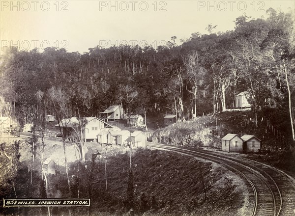 Ipswich railway station. Wooden buildings constructed on cleared forest land surround the track at Ipswich railway station. Ipswich, Jamaica, circa 1895. Ipswich, St Elizabeth, Jamaica, Caribbean, North America .