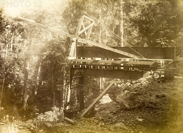 Railway viaduct under construction. Construction equipment in place at the site of a partially completed trestle bridge, one of several viaducts built to carry new railway lines. Jamaica, circa 1895. Jamaica, Caribbean, North America .