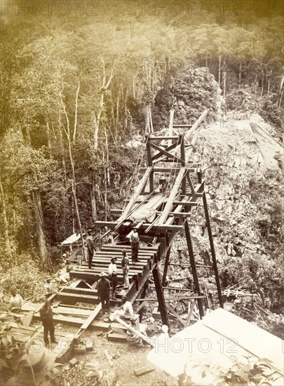 Railway viaduct under construction. Labourers work on the construction of a new trestle bridge over a steep valley, one of several viaducts built to carry new railway lines. Jamaica, circa 1895. Jamaica, Caribbean, North America .