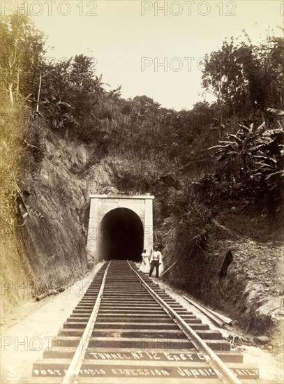Railway tunnel 'No. 12'. A couple stand at the entrance to railway tunnel 'No. 12', located on the extension line to Port Antonio, a stretch of track that opened in 1896. Portland, Jamaica, circa 1895., Portland, Jamaica, Caribbean, North America .