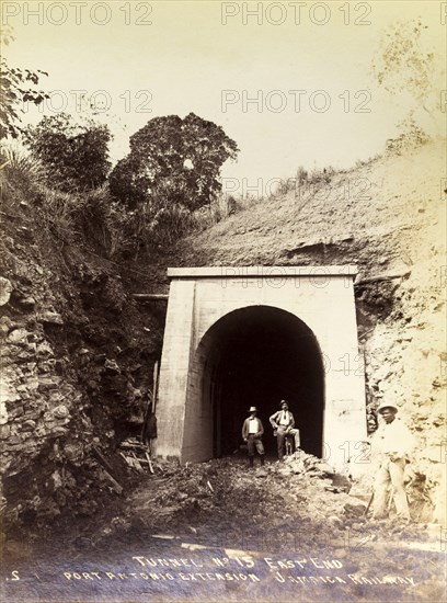 Completion of tunnel 'No. 15'. Two engineers pose amongst the rubble at the entrance to newly completed railway tunnel 'No. 15'. The tunnel is shown before the construction of the railway track that would later run beneath it as part of the Port Antonio extension line. Portland, Jamaica, circa 1895., Portland, Jamaica, Caribbean, North America .