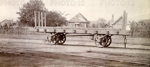 Jamaica Railway wagon. An open railway wagon sits on rails at a siding. Jamaica, circa 1895. Jamaica, Caribbean, North America .