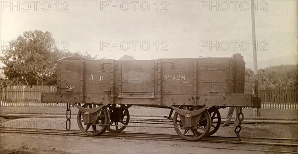 Jamaica Railway wagon. An open railway wagon inscribed 'J.R. No.128', sits on rails at a siding. Jamaica, circa 1895. Jamaica, Caribbean, North America .