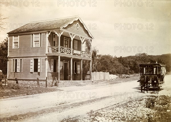 Jamacia Street Car Company. Two mules pull an open-sided tram along rails past a building idenitifed as: 'Jamaica Street Car Co. Limited'. Kingston, Jamaica, circa 1895. Kingston, Kingston, Jamaica, Caribbean, North America .