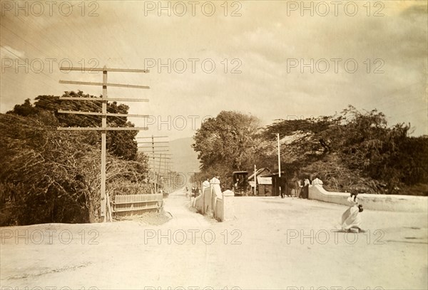 Kingston tram lines. Rails laid down for mule-drawn trams criss-cross a road bridge flanked by telegraph poles. Kingston, Jamaica, circa 1895. Kingston, Kingston, Jamaica, Caribbean, North America .