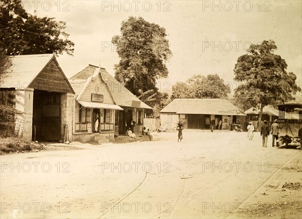 Jamaica Street Car Company. Rails laid down for mule-drawn trams criss-cross a wide, empty road outside a building identified as: 'Jamaica Street Car Co. Limited'. Kingston, Jamaica, circa 1895. Kingston, Kingston, Jamaica, Caribbean, North America .