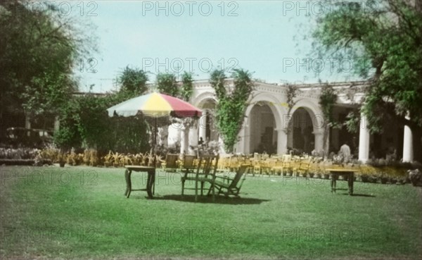 Laurie's Hotel, Agra. Deckchairs and a parasol, set up on the lawn outside Laurie's Hotel. Agra, United Provinces (Uttar Pradesh), India, circa 1925. Agra, Uttar Pradesh, India, Southern Asia, Asia.