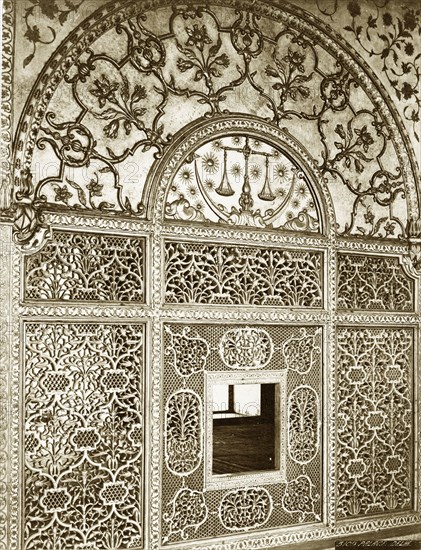 Scales of Justice' screen. An intricately carved marble screen in the Khas Mahal. The semi-circular panel of the screen depicts a crescent moon, stars and the scales of justice, the latter used as a regal emblem. The lower section is carved in a floral and lattice work design. Delhi, India, circa 1880. Delhi, Delhi, India, Southern Asia, Asia.