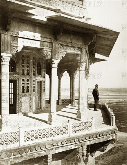 View from the Samman Burj. A lone figure takes in the view from a balcony on the Samman Burj, an octagonal tower located within the Agra Fort complex. Agra, North Western Provinces (Uttar Pradesh), India, circa 1885. Agra, Uttar Pradesh, India, Southern Asia, Asia.