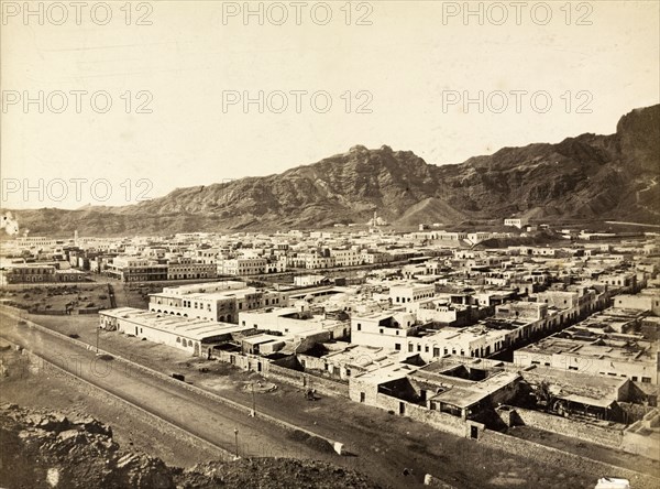 View of Aden. View of Aden, taken from a high vantage point looking towards the mountains that ring the city. A broad road dominates the foreground. Aden, Yemen, circa 1885. Aden, Adan, Yemen, Middle East, Asia.