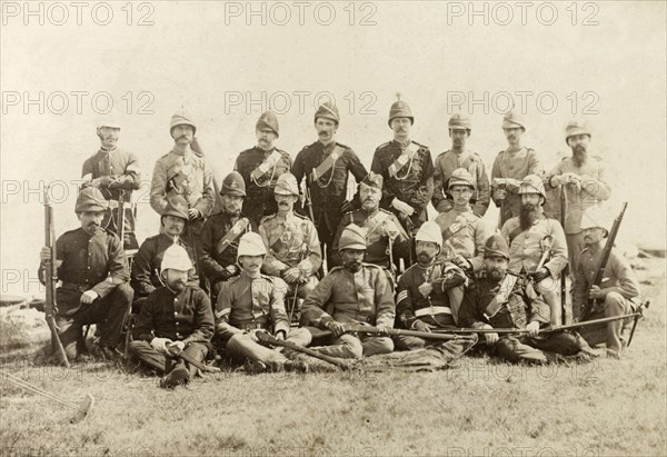 Wimbledon rifle team. 21 European and Indian members of a rifle team pose for a group portrait with their weapons, dressed in a variety of military uniforms. Wimbledon, England, circa 1889. Wimbledon, London, Greater, England (United Kingdom), Western Europe, Europe .