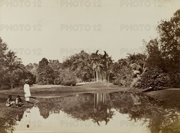 Pool in Eden Gardens. Three men relax beside the still waters of a pool in Eden Gardens. Calcutta (Kolkata), India, circa 1885. Kolkata, West Bengal, India, Southern Asia, Asia.