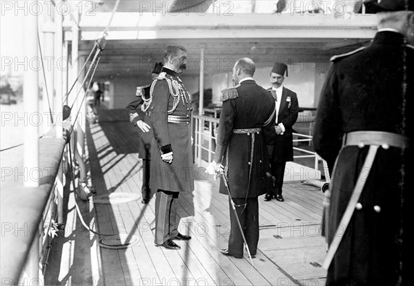 King George V and Lord Kitchener. King George V (r.1910-36) talks with Lord Kitchener (left) on the deck of HMS Medina, the ship transporting the royal couple to India for the Coronation Durbar at Delhi. Port Said, Egypt, 21 November 1911. Port Said, Port Said, Egypt, Northern Africa, Africa.
