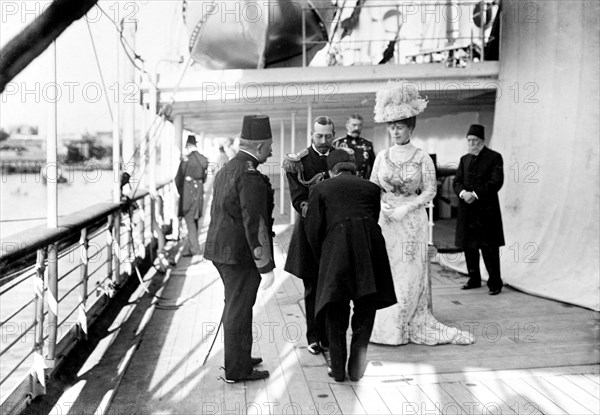 Farewells at Port Said. King George V (r.1910-36) accepts farewells from an unidentified official as the royal yacht, HMS Medina, prepares to depart from Port Said. The royal couple were on their way to India for the Coronation Durbar at Delhi. Port Said, Egypt, 21 November 1911. Port Said, Port Said, Egypt, Northern Africa, Africa.