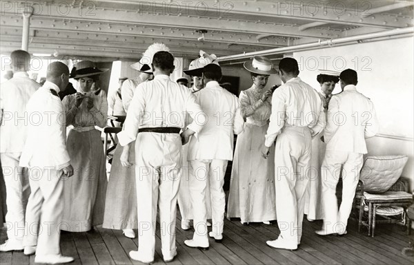 Royal thread-needle race. Queen Mary and her Ladies in Waiting participate in a thread-needle race aboard HMS Medina. The royal yacht was transporting King George V and Queen Mary to India for the Coronation Durbar at Delhi. Indian Ocean near Mumbai, India, circa 30 November 1911. India, Southern Asia, Asia.
