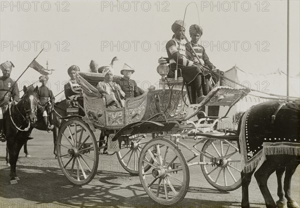 The Raja of Bilaspur. The Raja of Bilaspur arrives at the Coronation Durbar camp in an elaborate open carriage. He was one of many Indian princes who travelled to Delhi to pay homage to King George V, Emperor of India. Delhi, India, 8 December 1911. Delhi, Delhi, India, Southern Asia, Asia.