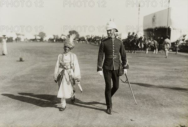 The Maharajah of Bharatpur. The Maharajah of Bharatpur accompanies a British officer across open ground following his presentation to King George V at the Coronation Durbar. Delhi, India, 8 December 1911. Delhi, Delhi, India, Southern Asia, Asia.