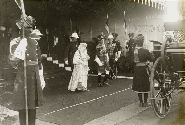 Nawab Sultan Jahan Begum. Nawab Sultan Jahan Begum (1858-1930), the Muslim ruler of Bhopal, leaves the royal reception tent at the Coronation Durbar. She is shrouded in a heavy, embroidered gown and wears a veil that covers her face. Delhi, India, 8 December 1911. Delhi, Delhi, India, Southern Asia, Asia.