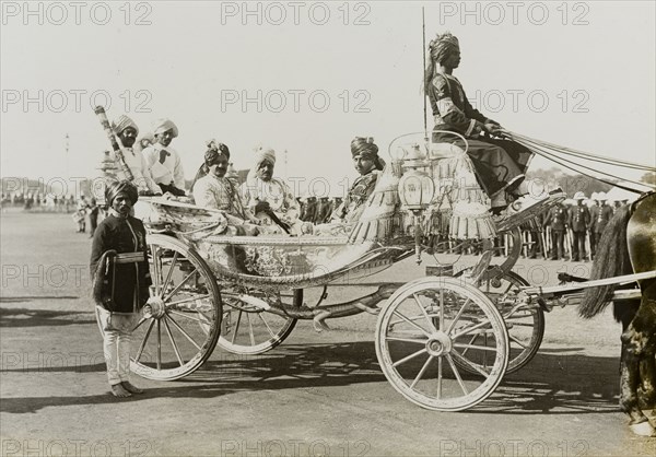 Maharajah at the Coronation Durbar. An unidentified Maharajah arrives at the Coronation Durbar camp in an elaborate open carriage. He was one of many Indian princes who travelled to Delhi to pay homage to King George V, Emperor of India. Delhi, India, 9 December 1911. Delhi, Delhi, India, Southern Asia, Asia.