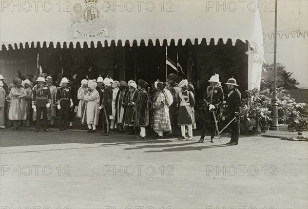Dignitaries at the Coronation Durbar. British officers and Indian dignitaries wait for carriages outside the royal tent following their presentation to King George V at the Coronation Durbar. Delhi, India, circa 8 December 1911. Delhi, Delhi, India, Southern Asia, Asia.