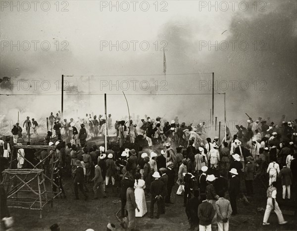 Fire at the Coronation Durbar. Onlookers face a cloud of smoke emitting from a fire at the Coronation Durbar camp. Delhi, India, circa 10 December 1911. Delhi, Delhi, India, Southern Asia, Asia.