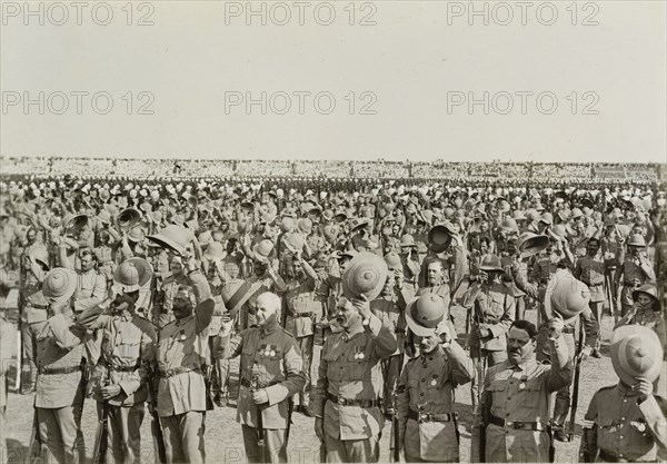 Three cheers for King George V. Numerous lines of uniformed soldiers stretch into the distance, each man raising his hat in a 'three cheers' salute to King George V following the Coronation Durbar. Delhi, circa 13 December 1911. Delhi, Delhi, India, Southern Asia, Asia.