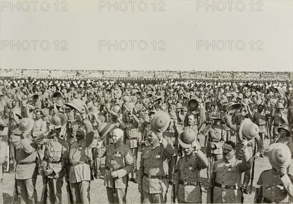 Three cheers for King George V. Numerous lines of uniformed soldiers stretch into the distance, each man raising his hat in a 'three cheers' salute to King George V following the Coronation Durbar. Delhi, circa 13 December 1911. Delhi, Delhi, India, Southern Asia, Asia.
