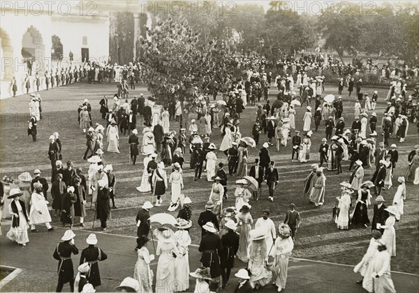 Coronation Durbar garden party. Formally dressed guests socialise on the lawns outside the Delhi Fort at a garden party held for King George V's Coronation Durbar. Delhi, India, circa 13 December 1911. Delhi, Delhi, India, Southern Asia, Asia.