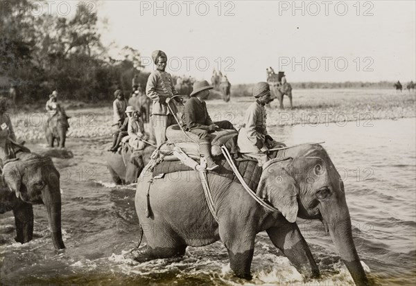 King George V crosses a river. King George V (r.1910-36) crosses a river on the back of an elephant during a royal hunt hosted by the Maharajah of Nepal. The King travelled to Nepal to hunt in Chitwan Valley following his Coronation Durbar in Delhi. Narayani, Nepal, circa 20 December 1911., Narayani, Nepal, Southern Asia, Asia.