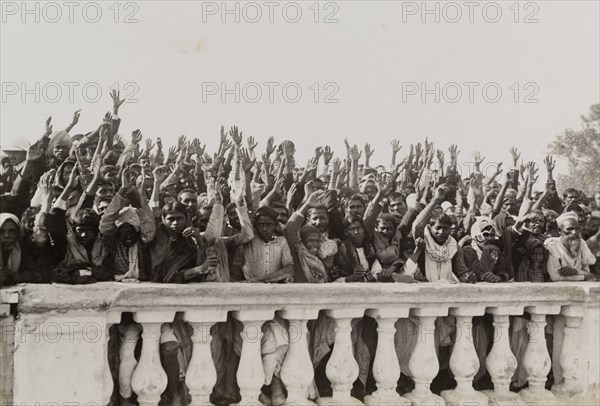 A loyal greeting for King George V's visit. An Indian crowd waves in greeting to a royal train carrying King George V from the Coronation Durbar in Delhi to Nepal. Probably United Provinces (Uttar Pradesh), Northern India, circa 15 December 1911., Uttar Pradesh, India, Southern Asia, Asia.