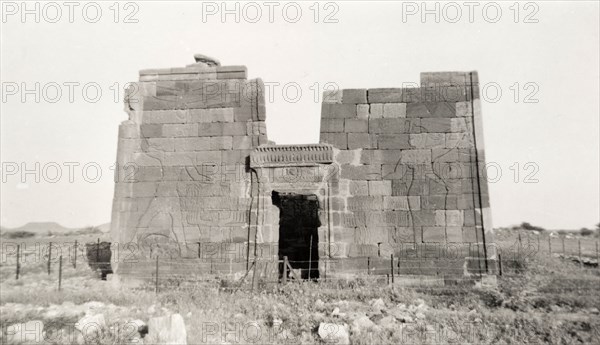 Ancient Egyptian-style ruins. Ruins of an ancient Egyptian-style building, displaying deep cut reliefs of figures on its face wall. Bir il Nagaa, Sudan, 1945. Bir il Nagaa, River Nile, Sudan, Eastern Africa, Africa.