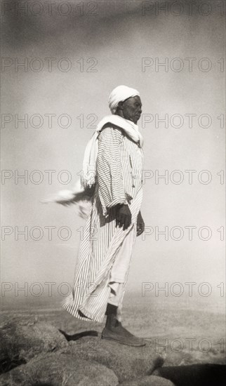 A Nuba 'mek' surveys his kingdom. A Nuba 'mek' or chief surveys his kingdom from the summit of a hill in the Otara Jebel range of the Nuba Mountains. South Kurdufan Province, Sudan, 1946., South Kurdufan, Sudan, Eastern Africa, Africa.