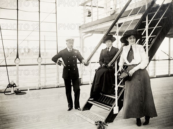 Duke of Connaught and family. The Duke of Connaught poses for a portrait with his wife, Duchess Luise Margarete, and his daughter, Princess Patricia, on the deck of S.S. Balmoral Castle. The royal couple were travelling to South Africa to open the new Union Parliament in Cape Town. Probably South Atlantic Ocean, Africa, October 1910. Africa.