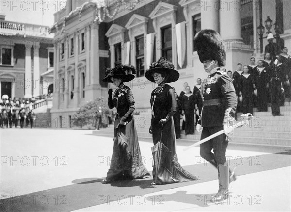 Duchess of Connaught and Princess Patricia at Cape Town. The Duchess of Connaught and her daughter, Princess Patricia, are escorted along a red carpet as they leave Cape Town's Houses of Parliament following the opening ceremony of the new Union Parliament. Cape Town, Cape Province (West Cape), South Africa, 4 November 1910. Cape Town, West Cape, South Africa, Southern Africa, Africa.