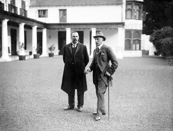 Duke of Connaught visits Bloemfontein. The Duke of Connaught (right) stands talking with a European dignitary in the driveway outside a colonial building. This was one of several stops made by the Duke following his official visit to Cape Town to open the new Union Parliament. Bloemfontein, Orange Free State (Free State), South Africa, 9 November 1910. Bloemfontein, Free State, South Africa, Southern Africa, Africa.