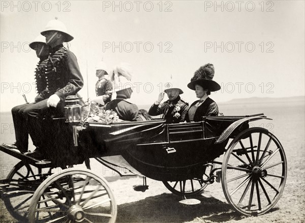 Duke and Duchess of Connaught in a carriage. The Duke and Duchess of Connaught depart in a horse-drawn carriage following their visit to a inspect a Guard of Honour. This was one of several stops made by the royal couple following their official visit to Cape Town to open the new Union Parliament. Bloemfontein, Orange Free State (Free State), South Africa, 9 November 1910. Bloemfontein, Free State, South Africa, Southern Africa, Africa.