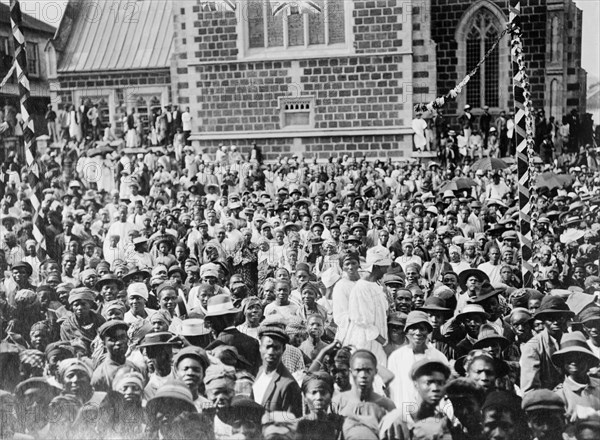 Crowd for the Duke of Connaught. A large crowd of African civillians gather outside a church in Salisbury at the reception of the Duke of Connaught. This was one of several stops made by the Duke following his official visit to Cape Town to open the new Union Parliament. Sailsbury, Southern Rhodesia (Harare, Zimbabwe), 18 November 1910. Harare, Harare City, Zimbabwe, Southern Africa, Africa.