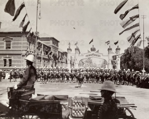 Cavalry parade for the Duke of Connaught. A British cavalry regiment lines up for a parade held in honour of the Duke and Duchess of Connaught who had recently opened the new Union Parliament at Cape Town. The courtyard is decorated with flags from around the British Empire. Probably Salisbury, Southern Rhodesia (Harare, Zimbabwe), circa 17 November 1910. Harare, Harare City, Zimbabwe, Southern Africa, Africa.