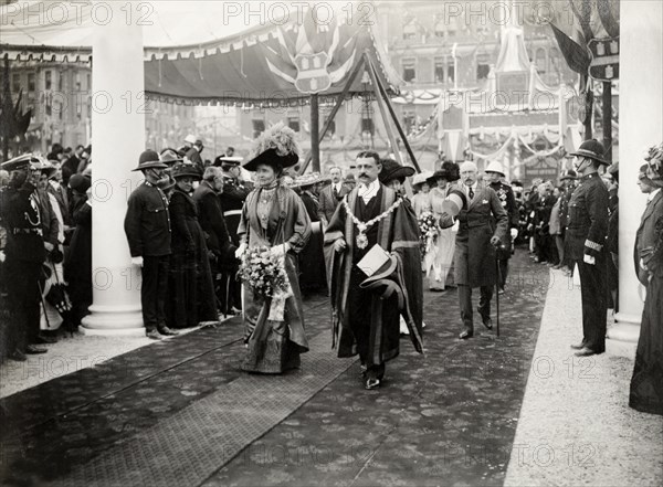 Duchess of Connaught with the Mayor of Salisbury. The Duchess of Connaught, followed by her husband and daughter, is escorted along a red carpet by the Mayor of Salisbury at a welcome reception. This was one of several stops made by the royal couple following their official visit to Cape Town to open the new Union Parliament. Salisbury, Southern Rhodesia (Harare, Zimbabwe), 18 November 1910. Harare, Harare City, Zimbabwe, Southern Africa, Africa.