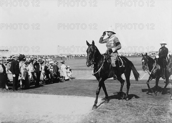 Duke of Connaught reviews the Volunteer Police. The Duke of Connaught salutes as he rides out to review a regiment of Volunteer Police officers. Salisbury, Southern Rhodesia (Harare, Zimbabwe), 17 November 1910. Harare, Harare City, Zimbabwe, Southern Africa, Africa.