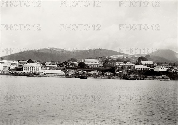 Coastal town in southern Africa. View of an unidentified coastal town surrounded by mountains. The photograph was taken during the Duke of Connaught's official tour of southern Africa, which culminated in the opening of the new Union Parliament at Cape Town. Southern Africa, circa 18 November 1910., Southern Africa, Africa.