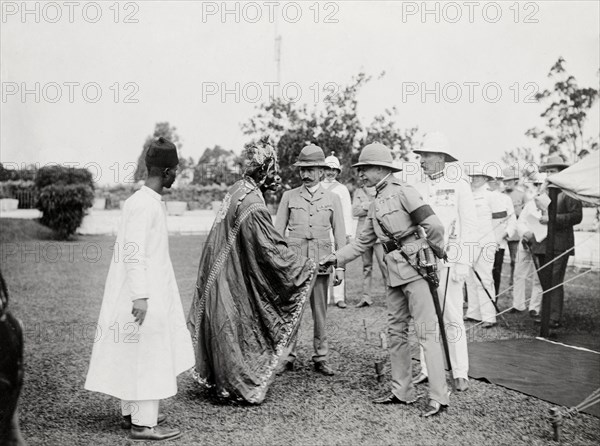 Duke of Connaught meets an African chief. The Duke of Connaught shakes hands with an African chief whilst attending an outdoor reception by Bechuanaland leaders. This was one of several stops made by the Duke following his official visit to Cape Town to open the new Union Parliament. Gaberones, Bechuanaland (Gaborone, Botswana), 24 November 1910. Gaborone, South East (Botswana), Botswana, Southern Africa, Africa.