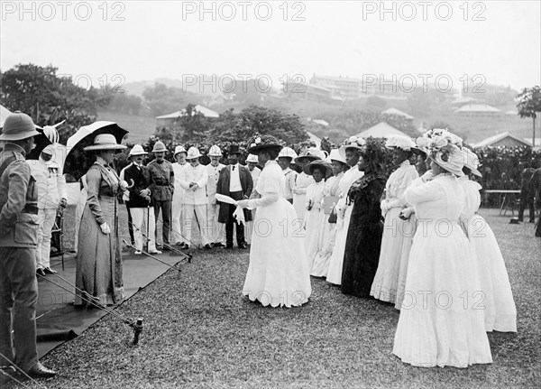 African women at a royal reception. The Duchess of Connaught addresses a group of local African women dressed in Western-style clothing at an outdoor reception by Bechuanaland chiefs. This was one of several stops made by the Duke following his official visit to Cape Town to open the new Union Parliament. Gaberones, Bechuanaland (Gaborone, Botswana), 24 November 1910. Gaborone, South East (Botswana), Botswana, Southern Africa, Africa.