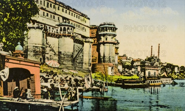 A bathing ghat at Benares. View of a bathing ghat (stepped wharf) on the River Ganges at Benares, one of Hinduism's holiest sites. Benares, United Provinces (Varanasi, Uttar Pradesh), India, circa 1920. Varanasi, Uttar Pradesh, India, Southern Asia, Asia.